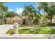 Charming home with a terracotta roof, 3-car garage, lush landscaping, and inviting curb appeal at 17812 Arbor Greene Dr, Tampa, FL 33647
