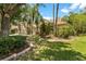 Well landscaped house with mature trees, shrubbery, and a terracotta colored roof at 17812 Arbor Greene Dr, Tampa, FL 33647