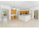 Open kitchen featuring an island, wood cabinets, and modern appliances at 17812 Arbor Greene Dr, Tampa, FL 33647