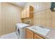 Functional laundry room with washer, dryer, overhead cabinets, and sink at 17812 Arbor Greene Dr, Tampa, FL 33647
