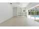 Bright living room features built-in shelving and sliding doors that lead to the pool area at 17812 Arbor Greene Dr, Tampa, FL 33647