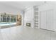 Bright living room featuring tile floors, a fireplace, and seamless access to the outdoor pool area at 17812 Arbor Greene Dr, Tampa, FL 33647
