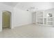 Open living room with an archway and built-in shelving perfect for entertaining at 17812 Arbor Greene Dr, Tampa, FL 33647