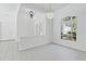 Bright living area with elegant chandeliers, tile flooring, and a decorative entry at 17812 Arbor Greene Dr, Tampa, FL 33647