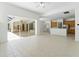 Spacious living room featuring access to the lanai and view of the kitchen with ample counter space at 17812 Arbor Greene Dr, Tampa, FL 33647