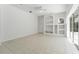 Bright living room with built-in shelving and a sliding glass door providing plenty of natural light at 17812 Arbor Greene Dr, Tampa, FL 33647