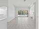 Bright living room features tile floors, a fireplace, and seamless access to the outdoor area at 17812 Arbor Greene Dr, Tampa, FL 33647