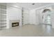 Spacious living area featuring tile flooring, a cozy fireplace, and elegant french doors at 17812 Arbor Greene Dr, Tampa, FL 33647