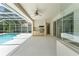 Poolside patio with an outdoor kitchen with sink and outdoor grill and patio furniture at 17812 Arbor Greene Dr, Tampa, FL 33647
