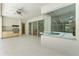 Spacious covered patio with ceiling fan, outdoor kitchen, and view of the pool at 17812 Arbor Greene Dr, Tampa, FL 33647