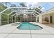 Backyard features a pool and spa, with a screened-in enclosure offering privacy and comfort at 17812 Arbor Greene Dr, Tampa, FL 33647