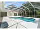 Screened-in pool area with in-ground pool, spa, and large patio at 17812 Arbor Greene Dr, Tampa, FL 33647