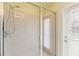 This bathroom features a glass-enclosed shower with neutral tile and a door to the pool at 17812 Arbor Greene Dr, Tampa, FL 33647