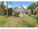 Well-maintained backyard with a screened pool enclosure, creating a private and relaxing outdoor space at 17812 Arbor Greene Dr, Tampa, FL 33647