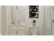 Bright bathroom featuring a glass-enclosed shower, a white vanity, and a black and white print at 18465 Serene Lake Loop, Lutz, FL 33548