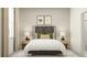Relaxing bedroom featuring a comfortable bed, bedside tables with lamps, and decorative wall art at 18465 Serene Lake Loop, Lutz, FL 33548