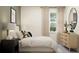 Airy bedroom with a plush bed, side tables, stylish décor, and lots of natural light at 18465 Serene Lake Loop, Lutz, FL 33548