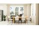 Bright dining area with a wooden table, comfortable seating, and large windows for natural light at 18465 Serene Lake Loop, Lutz, FL 33548