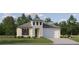 Charming single-story home with a two-car garage, shutters, and a beautifully landscaped front yard at 18465 Serene Lake Loop, Lutz, FL 33548