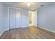 Bright bedroom featuring wood-look flooring, a ceiling fan, and a spacious closet at 2039 Lyra Dr, Holiday, FL 34690