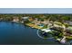 Aerial view showcasing a waterfront property with a pool and boat dock and gulf access and mature landscaping at 263 87Th N Ave, St Petersburg, FL 33702