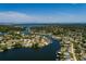 Aerial view of a waterfront community surrounded by canals, mature trees, and picturesque residential homes at 263 87Th N Ave, St Petersburg, FL 33702
