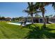 Backyard with a manicured lawn, pool, modern home and patio at 263 87Th N Ave, St Petersburg, FL 33702