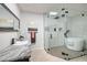 Elegant bathroom featuring a glass-enclosed shower and tub, with designer tile and fixtures at 263 87Th N Ave, St Petersburg, FL 33702