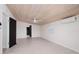 Bedroom with white walls, tile flooring, wood plank ceiling, mini split system, and a ceiling fan at 263 87Th N Ave, St Petersburg, FL 33702