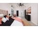 Modern bedroom with terrazzo floors, accent chair, and a view of the outside, creating a serene retreat at 263 87Th N Ave, St Petersburg, FL 33702