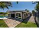 Side exterior showing private outdoor shower, rock path, and lush landscaping for added privacy at 263 87Th N Ave, St Petersburg, FL 33702
