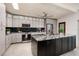 Modern kitchen features stainless steel appliances, light gray cabinets, and a center island at 263 87Th N Ave, St Petersburg, FL 33702