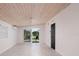 Bright living room features wood ceiling, ceiling fan, tile flooring, and sliding glass doors at 263 87Th N Ave, St Petersburg, FL 33702