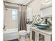Updated bathroom with white subway tile, custom vanity, and a tub and shower combo at 2635 Manatee Harbor Dr, Ruskin, FL 33570