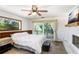 Cozy bedroom featuring a large window, sliding glass door to the balcony, and neutral decor at 2635 Manatee Harbor Dr, Ruskin, FL 33570
