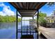 Boat dock with boat lift extending into the calm river at 2635 Manatee Harbor Dr, Ruskin, FL 33570