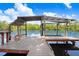 Waterfront property featuring a private boat dock with cover, offering convenient access to the serene waterway at 2635 Manatee Harbor Dr, Ruskin, FL 33570