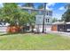 Charming two-story home with a stone facade and lush green lawn, providing curb appeal at 2635 Manatee Harbor Dr, Ruskin, FL 33570