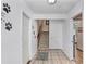Hallway featuring tile flooring, doors, stairs, and paw-themed decorations at 2635 Manatee Harbor Dr, Ruskin, FL 33570