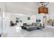 Large open living room with high ceilings, marble floors, and a comfortable black sectional sofa at 2635 Manatee Harbor Dr, Ruskin, FL 33570
