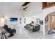 Spacious living room with high ceilings, marble floors, and a comfortable black sectional sofa at 2635 Manatee Harbor Dr, Ruskin, FL 33570