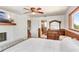 Bright bedroom boasts a fireplace, ceiling fan, and wood trim with an en suite bathroom at 2635 Manatee Harbor Dr, Ruskin, FL 33570