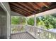 Covered porch with wood flooring and a view of lush greenery and a nearby lake at 2635 Manatee Harbor Dr, Ruskin, FL 33570