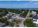 Scenic aerial view of a neighborhood with mature trees and a glimpse of the ocean in the background at 3021 W Helen Ave, Tampa, FL 33611