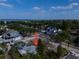 An aerial view of a residential neighborhood with mature trees, homes, and a glimpse of the ocean in the distance at 3021 W Helen Ave, Tampa, FL 33611