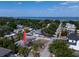 Scenic aerial view of a neighborhood with mature trees and a glimpse of the ocean in the background at 3021 W Helen Ave, Tampa, FL 33611