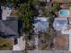 Aerial perspective of residential properties with varying roof styles and landscaping at 3021 W Helen Ave, Tampa, FL 33611