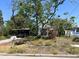 A single-story home with a carport and mature trees offering shade and character at 3021 W Helen Ave, Tampa, FL 33611
