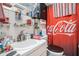 A uniquely decorated bathroom with Coca-Cola themed accessories including shower curtain and decor at 3115 W Wyoming Ave, Tampa, FL 33611