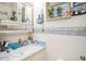 Cozy bathroom with unique blue and white floral wallpaper and a mirror vanity at 3115 W Wyoming Ave, Tampa, FL 33611